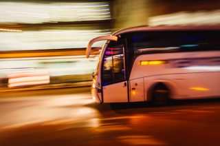 Large Tourist Bus Travels Fast In The City