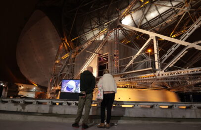 Deux personnes contemplent l’antenne PB1 située sous le radôme lors des Journées européennes du patrimoine 2025.